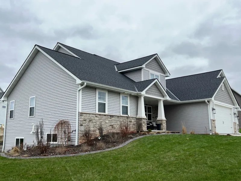 Completed home with new dark shingle roof